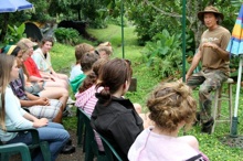 4-H group and New Zealand youth group listening to farmer
